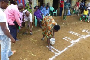 Villagers engaged in producing ground map of Kombone Mission